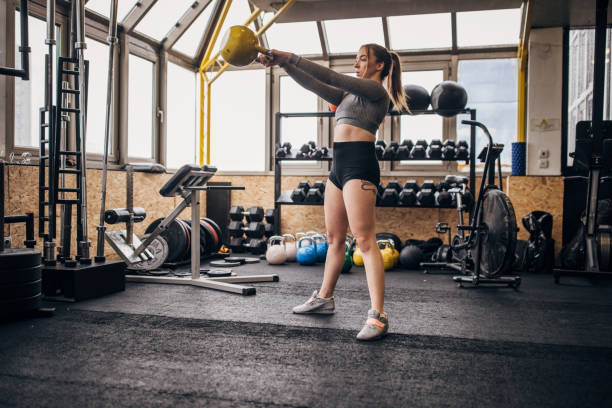 istock Woman training with kettlebell in gym 1366741502