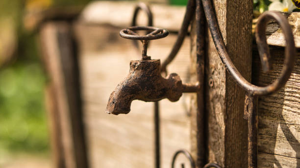 Faucet as deco in old with rust on a wooden board. Detailed and textured decoration