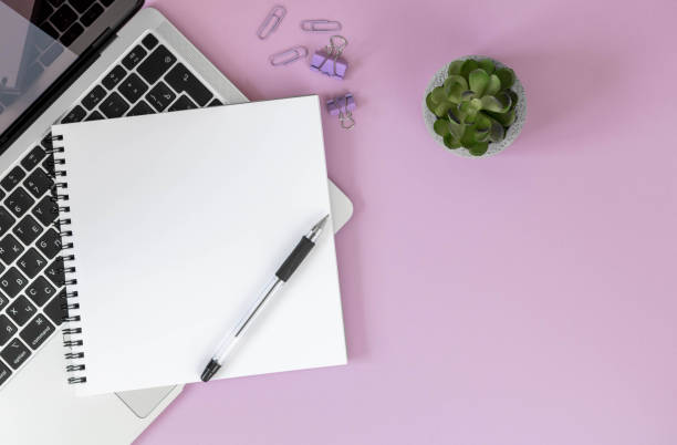 istock Workspace top view, copy space. Laptop, succulent, notepad, office supplies on purple background top view, copy space. 1366743953