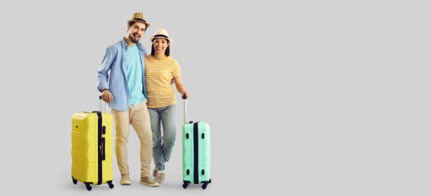 istock Couple with luggage bag standing hugging portrait with empty copy space aside 1366744241