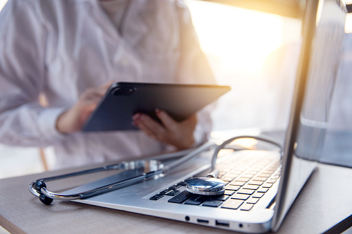 Doctor working with digital tablet