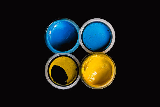 istock Open cans with blue and yellow dry gouache paint on a black background 1366745839