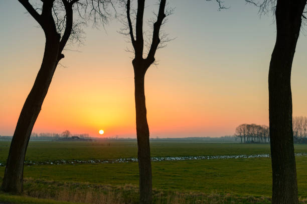 Sunset during a cold winter day in the IJsseldelta region in Overijssel, The Netherlands