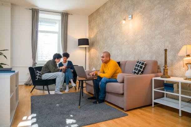 istock Hispanic Father Using Laptop Whine Mother and Son Are Using Digital Tablet 1366746045