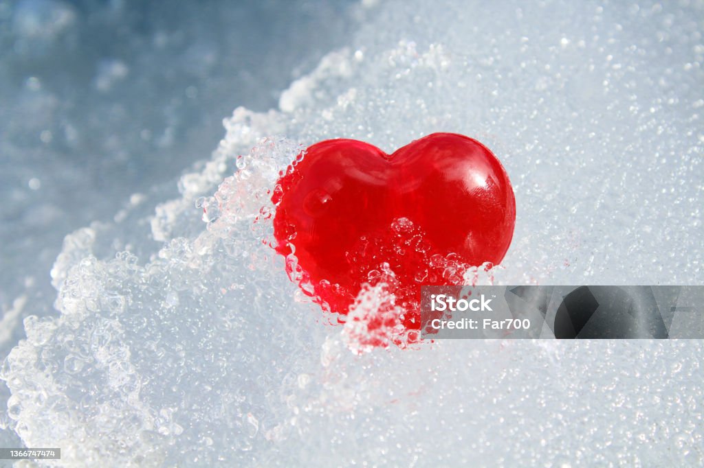 Red heart in ice. Close-up. Background. Texture. Backgrounds Stock Photo