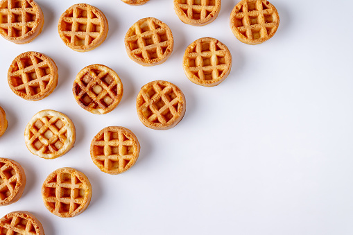round small waffles, pattern on white background