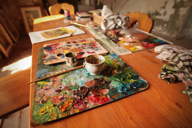 istock Palette with oil paints on a wooden table 1366751275