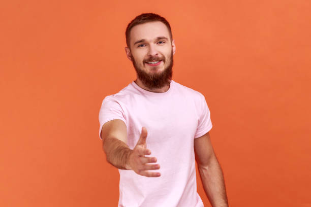 istock Man standing with outstretched hand, offering handshake to partner, greeting on job interview. 1366752458