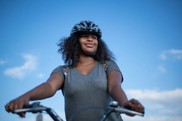 istock Young black woman riding a bike 1366752876