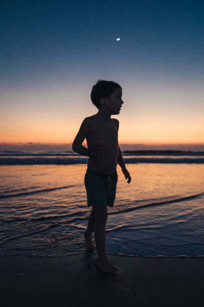 istock Boys playing at the beach during sunset 1366753634