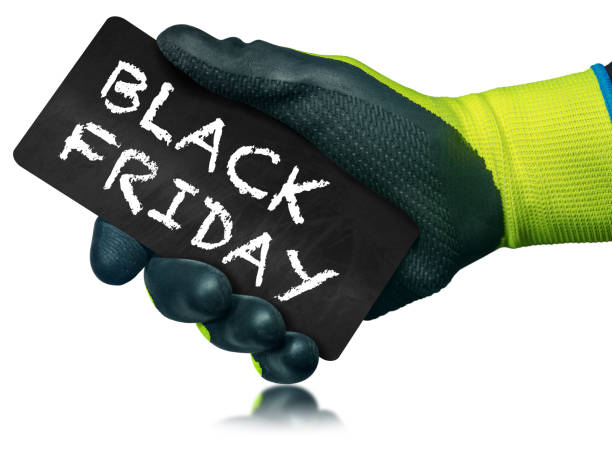 istock Gloved Hand Holding a Black Friday Sign isolated on white Background 1366753947