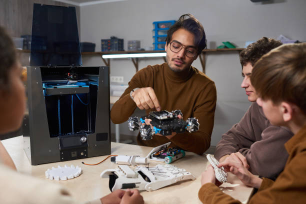 istock Teacher building a robotic machine at science school 1366754256