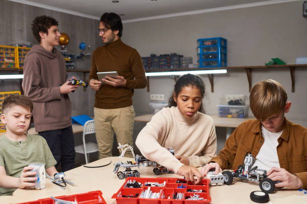 istock Group of teens projecting robots at science lesson 1366754808