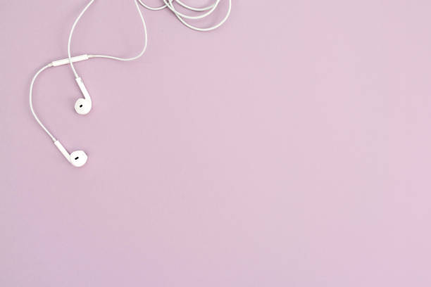 Minimalistic top view with white headphones on pastel background stock photo