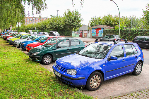 Frankfurt am Main, Germany - September 15, 2013: Line of bright compact cars in a city street.