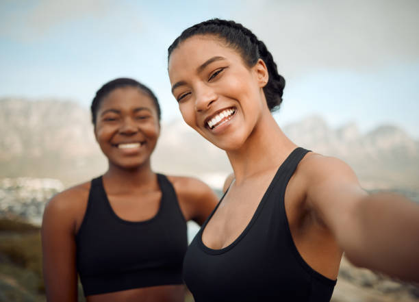 istock Shot of two friends taking selfies during a workout 1366755448