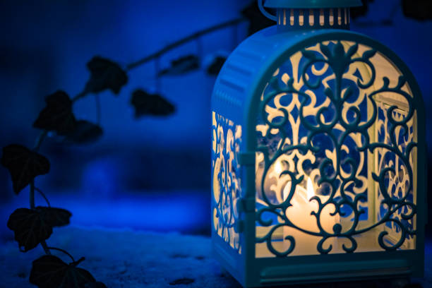 Festive lantern in the evening snowfall