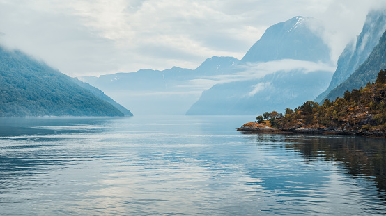 Scandinavian fjord landscape in the morning mist