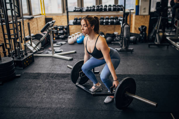 istock Woman body building in gym 1366757531