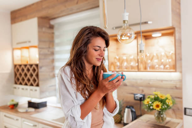 istock Woman drinking coffee at home 1366761140