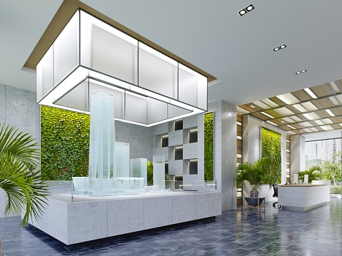 Real estate sales office with large glass building mock-up illuminated from above in modern interior. 3D rendering.