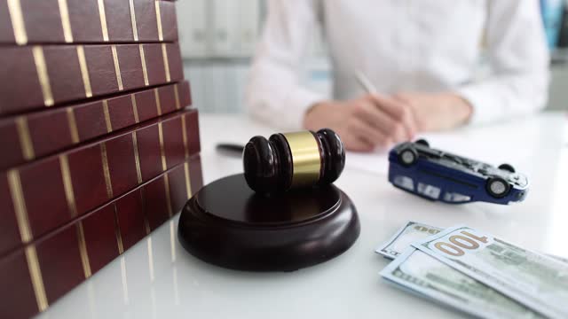 Judge gavel with upside down toy car closeup
