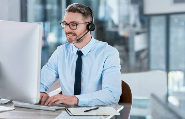 istock Shot of a mature call centre agent working on a computer in an office 1366763743