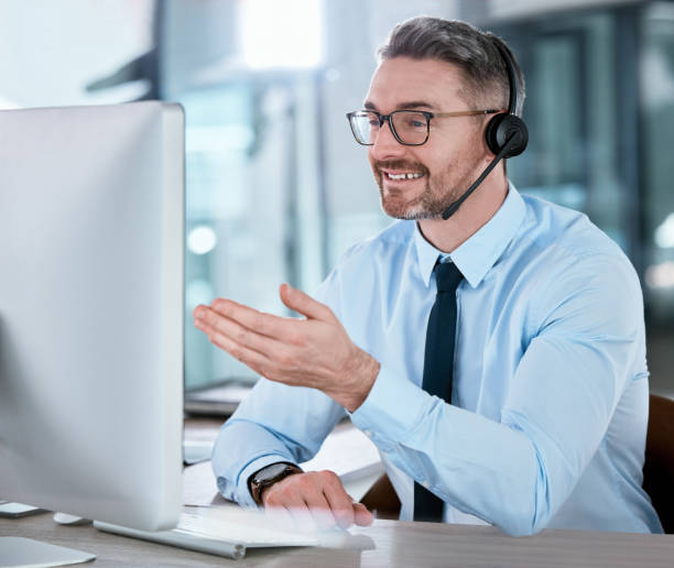 istock Shot of a mature call centre agent working on a computer in an office 1366763756