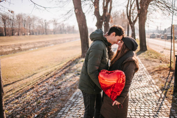 istock Couple holding hot air heart shaped balloon 1366763765