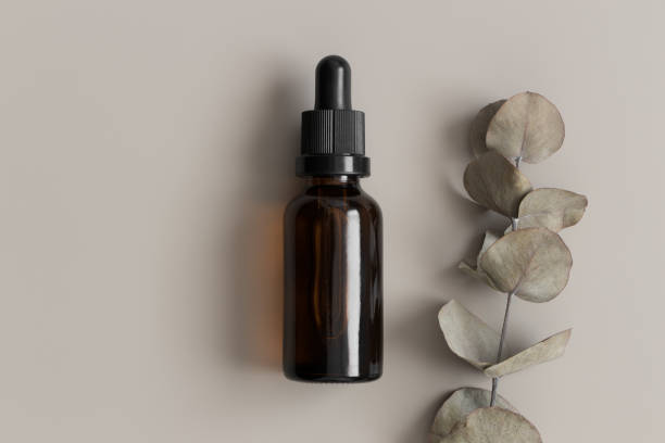 istock Dropper bottle mockup with an eucalyptus on the beige background. 1366765886