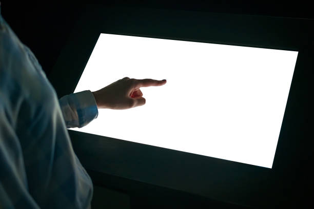 istock Woman touching white blank display of interactive kiosk - mockup image 1366768220