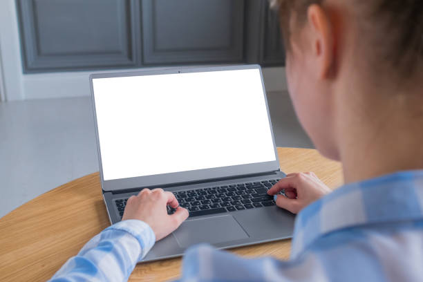 istock Woman student typing on grey laptop computer keyboard with white blank screen 1366768325