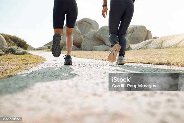 Shot of two women jogging together