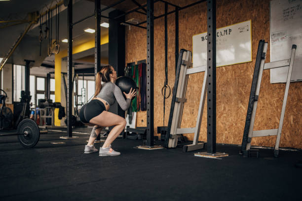 istock Woman training with medicine ball 1366772093