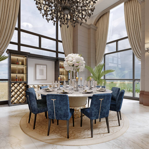 istock Large luxurious dining table in the large living room with high ceilings in a modern classic style with blue chairs and a white table. 1366772422
