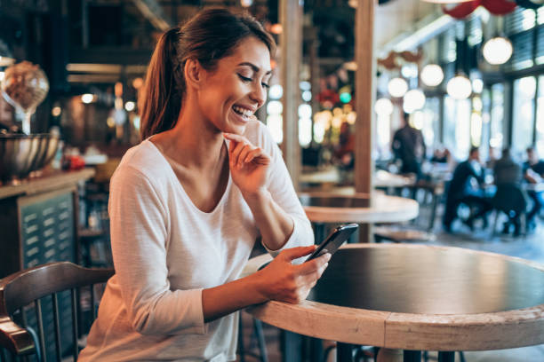 istock Woman using smartphone at a lovely cafe. 1366775691