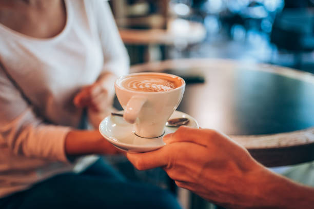 istock Waiter serving coffee to customer in city cafe. 1366775695