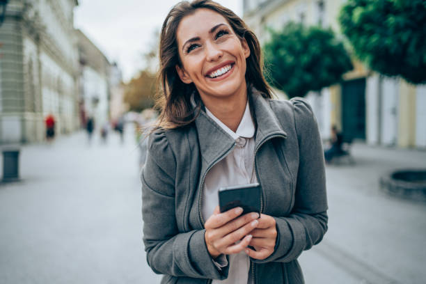 istock Woman using smart phone in the city. 1366775721