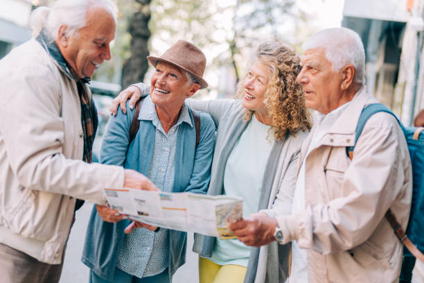 istock Cheerful senior tourists exploring foreign city using a map. 1366775740