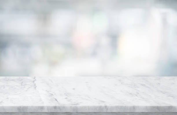 istock Selective focus.Marble table top on blur abstract window glass background. 1366777133