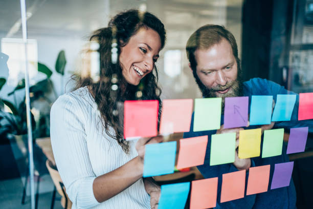Businesspeople brainstorming with adhesive notes in a meeting
