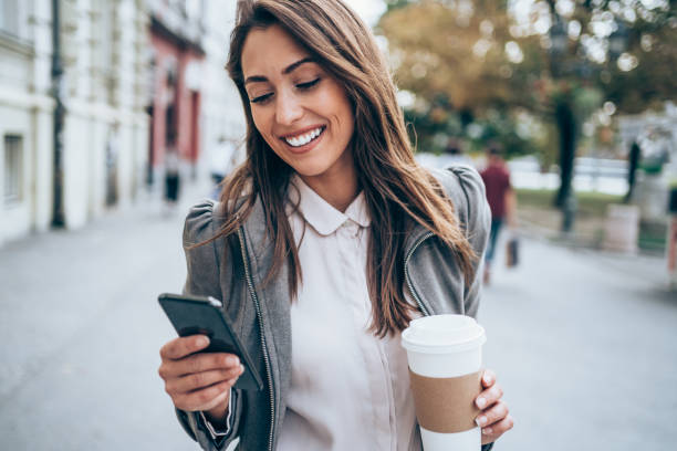 istock Young woman texting on the street. 1366778245