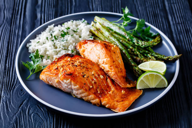 istock fried salmon fish fillet with rice and asparagus 1366779265