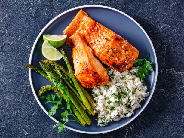 istock fried salmon fish fillet with rice and asparagus 1366779267