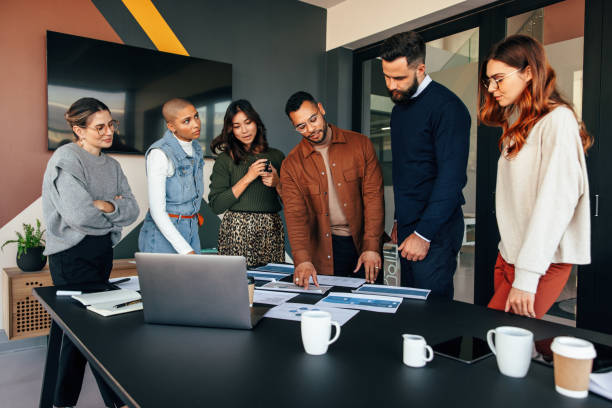istock Team of businesspeople discussing some documents in a boardroom 1366779650