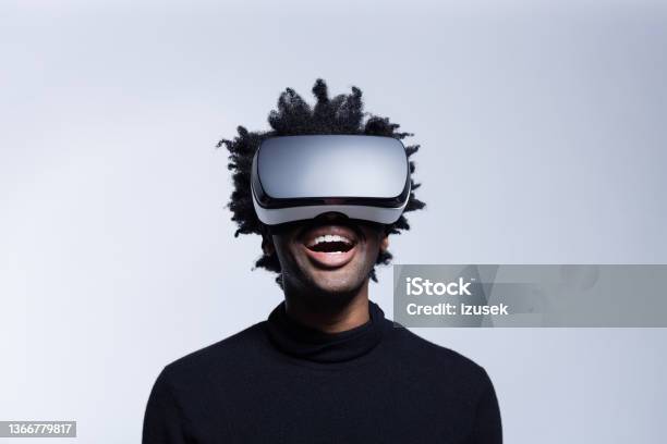 Happy Young Man Using Virtual Reality Glasses Stock Photo - Download Image Now - Virtual Reality Simulator, Virtual Reality, Arts Culture and Entertainment