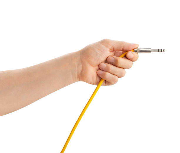 instrumental cable in hand instrumental cable in hand path isolated on white amplifier plug stock pictures, royalty-free photos & images