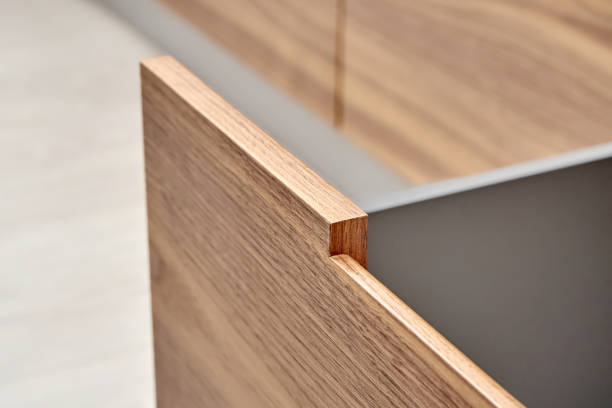 istock Open drawer with facade of walnut wood with finger pull design close-up 1366782185