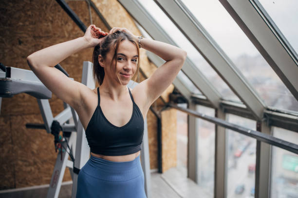 istock Cute woman standing in gym 1366782313