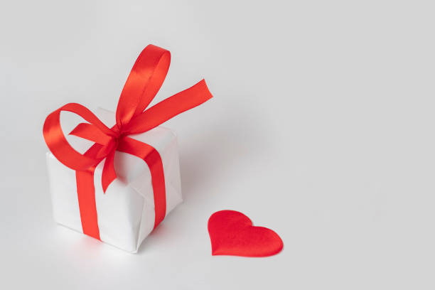 istock white background for valentine's day gift box with red ribbon and heart 1366783157